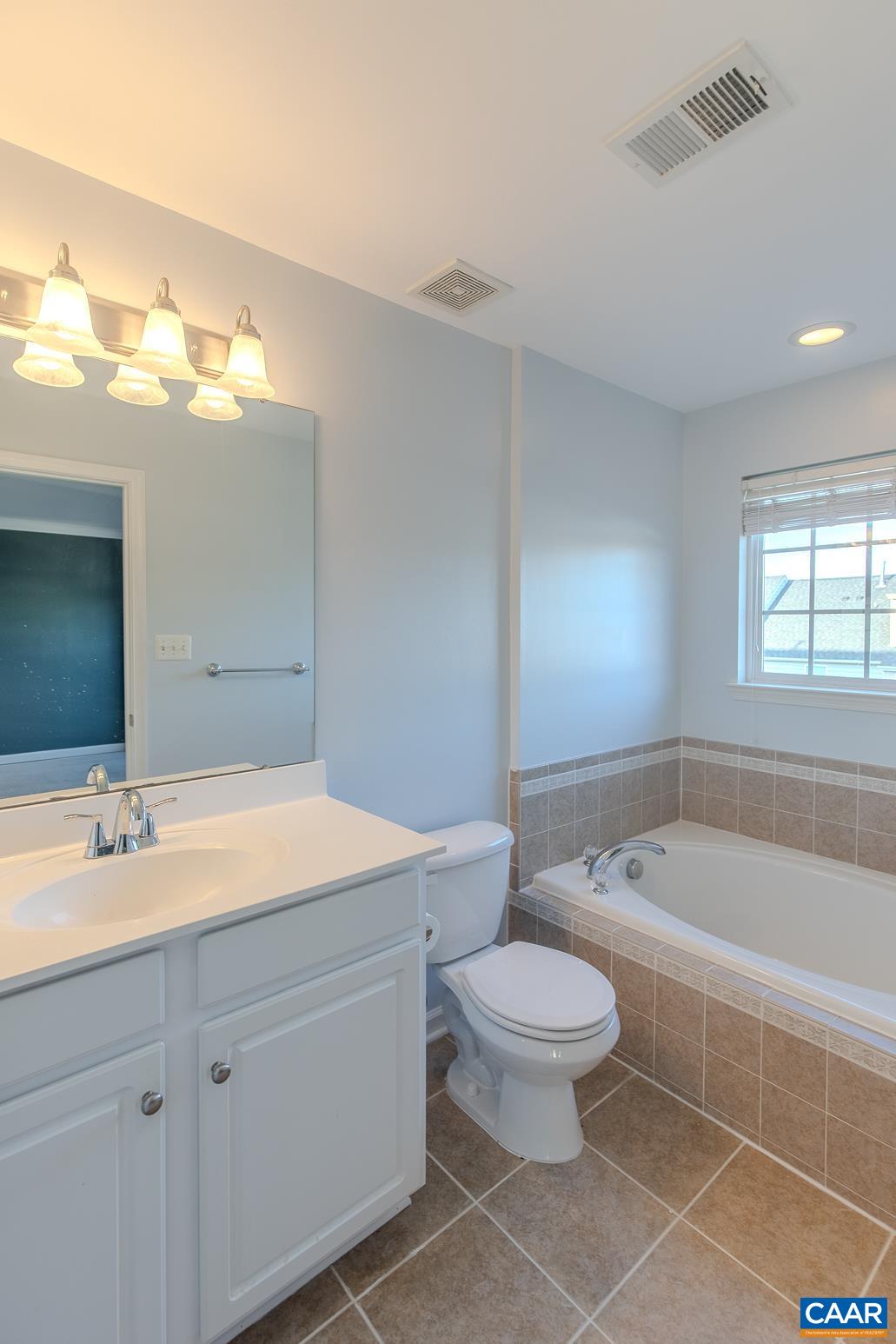339 Rolkin Road Charlottesville, VA 22911 - Photo 23 of 43 a spacious bathroom with a granite countertop sink a toilet and a bathtub
