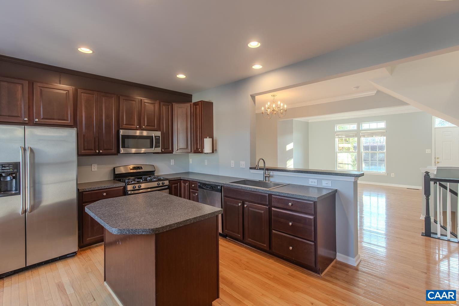 339 Rolkin Road Charlottesville, VA 22911 - Photo 9 of 43 a kitchen with a sink stove a refrigerator and wooden cabinets