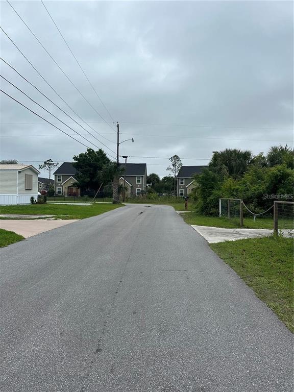 1015 Elm Street Punta Gorda, FL 33950 - Photo 6 of 13 a view of a road with a yard and a car park