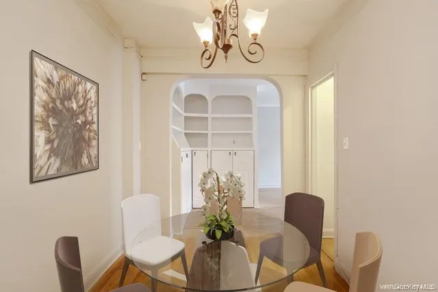 a view of a dining room with furniture wooden floor and a chandelier