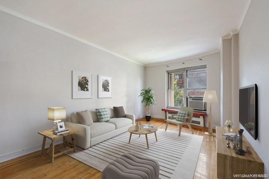 110-55 72nd Road, Unit 106 Queens, NY 11375 - Photo 8 of 10 a living room with furniture and a flat screen tv