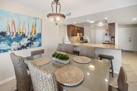a kitchen with kitchen island granite countertop a sink a counter space cabinets and stainless steel appliances
