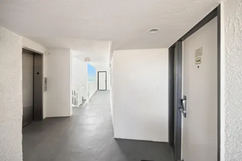 a bathroom with a glass shower door and a sink