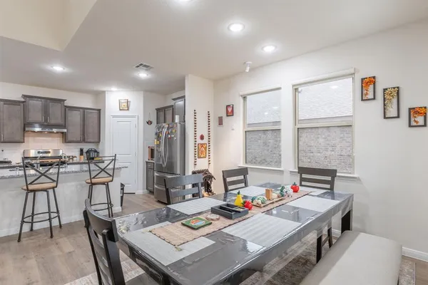 a kitchen with a refrigerator and a stove top oven