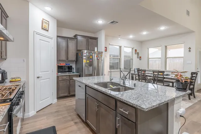 a kitchen with refrigerator cabinets and center island