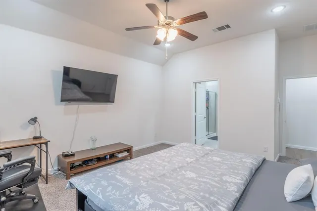 a bedroom with a bed and a flat screen tv