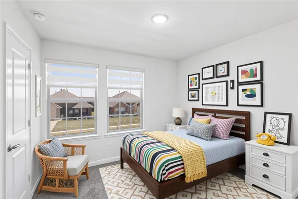 a bedroom with a bed and painting on the wall