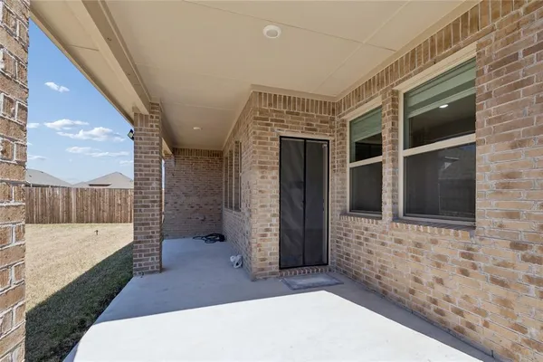 a view of a garden with a small yard and wooden fence