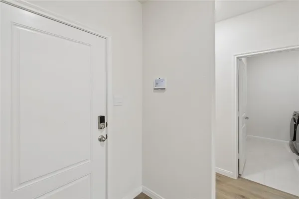 a view of a hallway with wooden floor