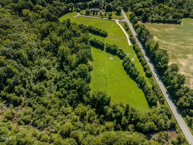 a view of a yard with potted plants