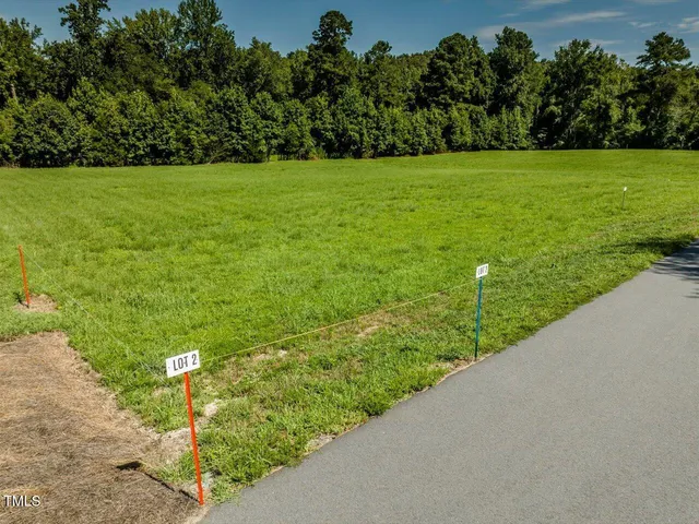 a view of a garden with a building in the background