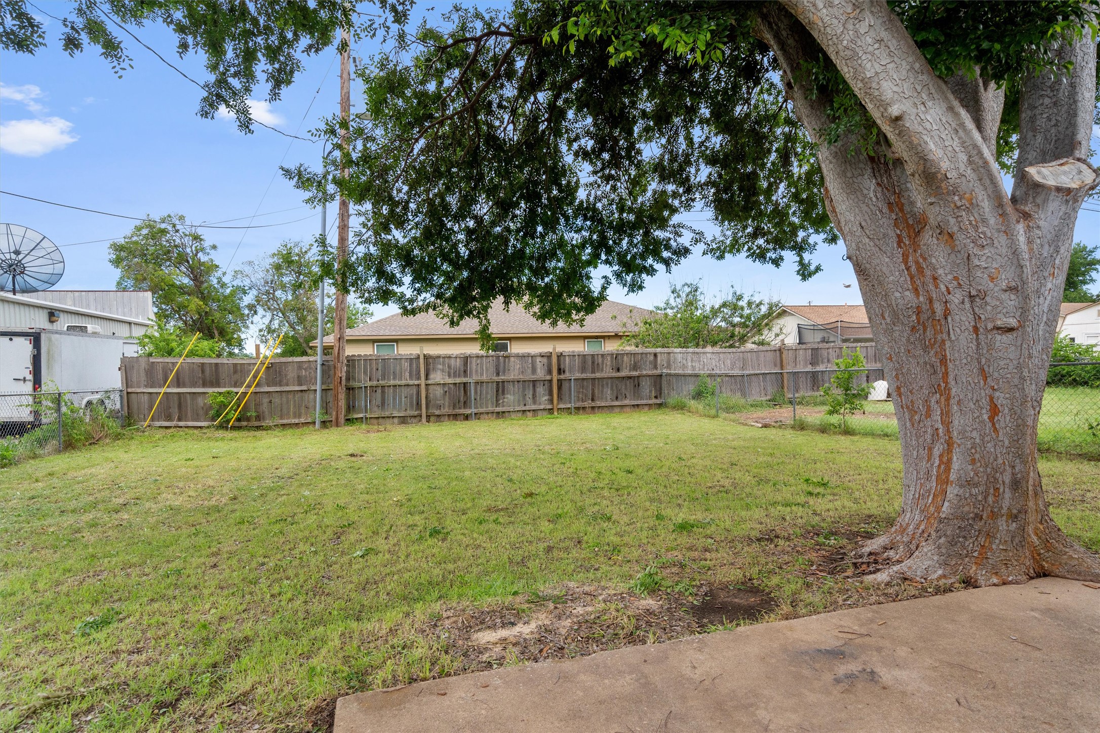 2805 Davis Street, Unit A Taylor, TX 76574 - Photo 10 of 12 a view of a yard with a large tree