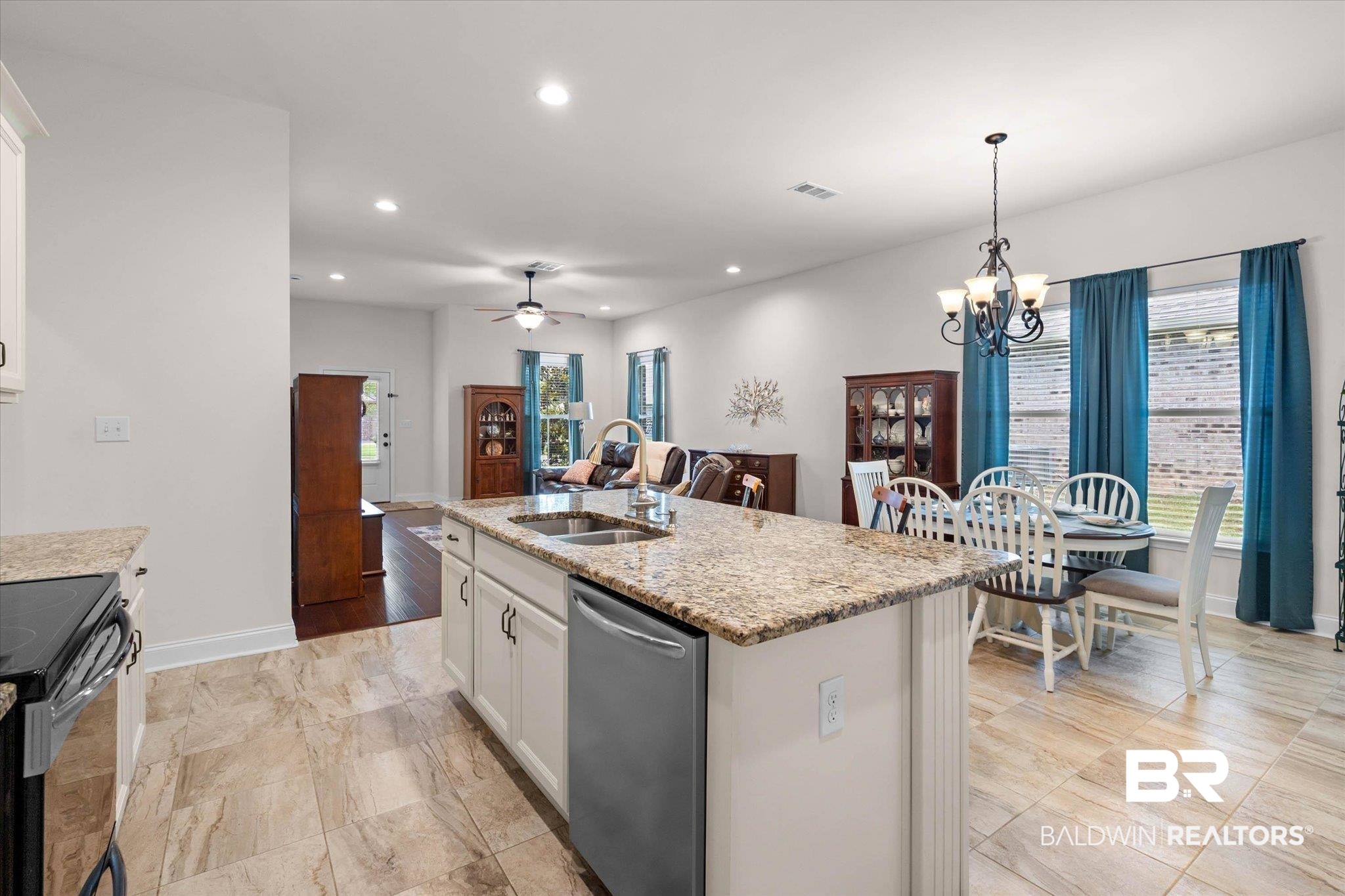 1270 Surrey Loop Foley, AL 36535 - Photo 9 of 27 Kitchen island featuring a stainless steel sink and integrated dishwasher