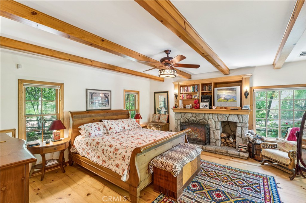 28971 North Shore Road Lake Arrowhead, CA 92352 - Photo 28 of 60 a bedroom with a bed a flat screen tv and a dresser next to a window