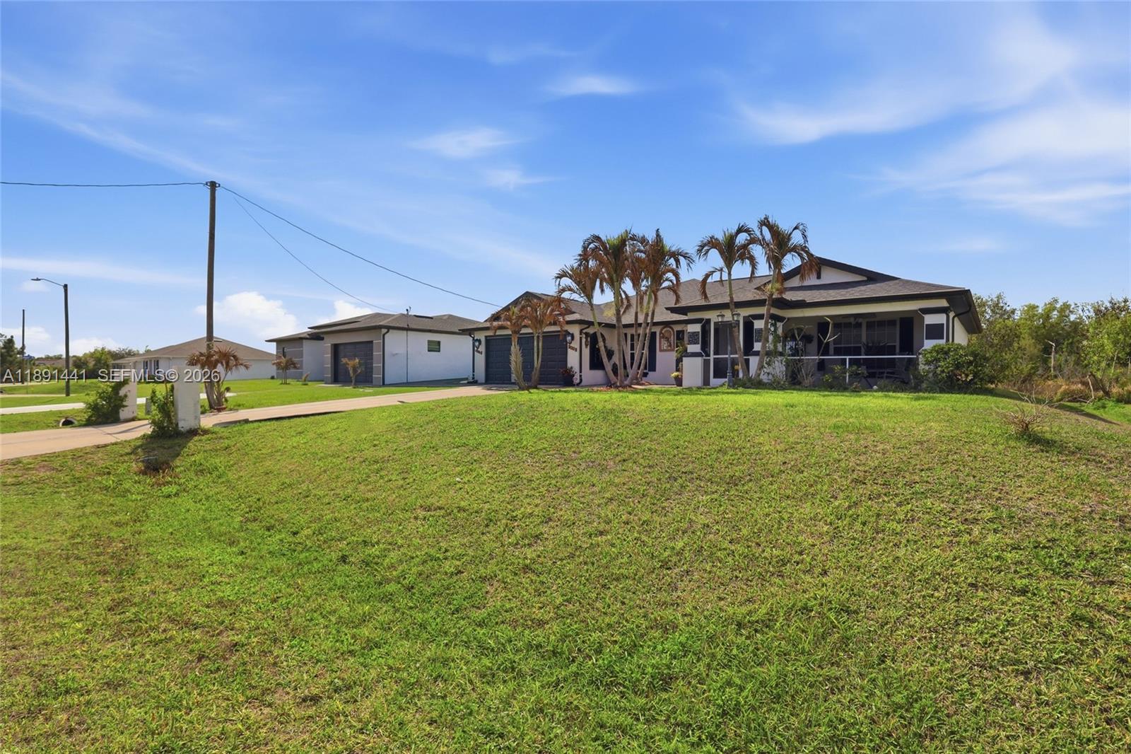 3003 25th Street West Lehigh Acres, FL 33971 - Photo 15 of 39 a view of a house with a big yard and potted plants