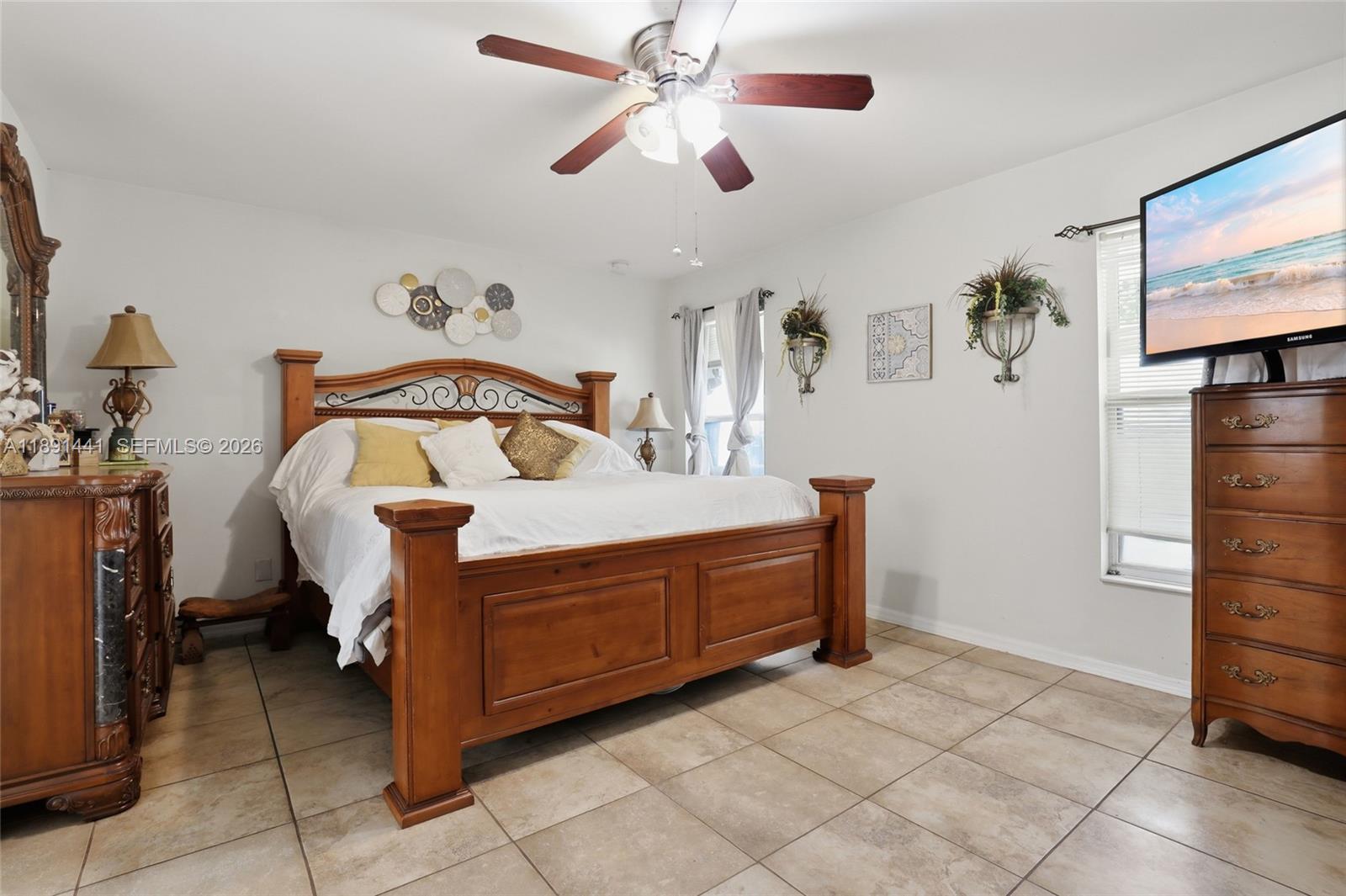 3003 25th Street West Lehigh Acres, FL 33971 - Photo 17 of 39 a bedroom with a bed and a chandelier