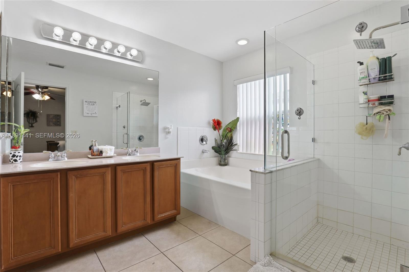 3003 25th Street West Lehigh Acres, FL 33971 - Photo 20 of 39 a bathroom with a double vanity sink mirror and shower