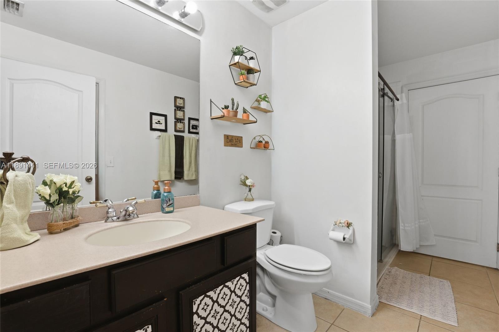3003 25th Street West Lehigh Acres, FL 33971 - Photo 24 of 39 a bathroom with a sink a toilet and vanity