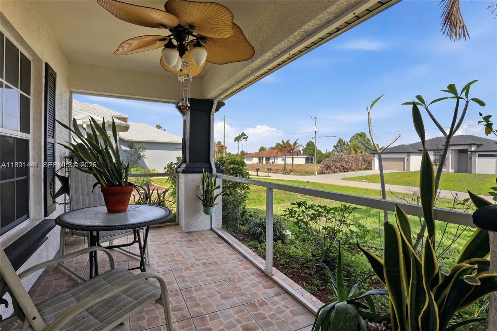 3003 25th Street West Lehigh Acres, FL 33971 - Photo 29 of 39 a view of a porch with furniture and a yard