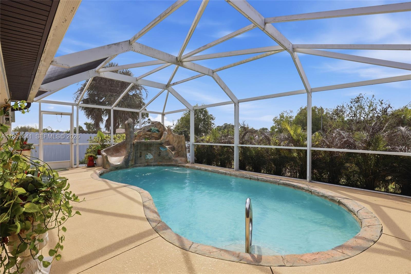 3003 25th Street West Lehigh Acres, FL 33971 - Photo 39 of 39 a view of a swimming pool with a yard