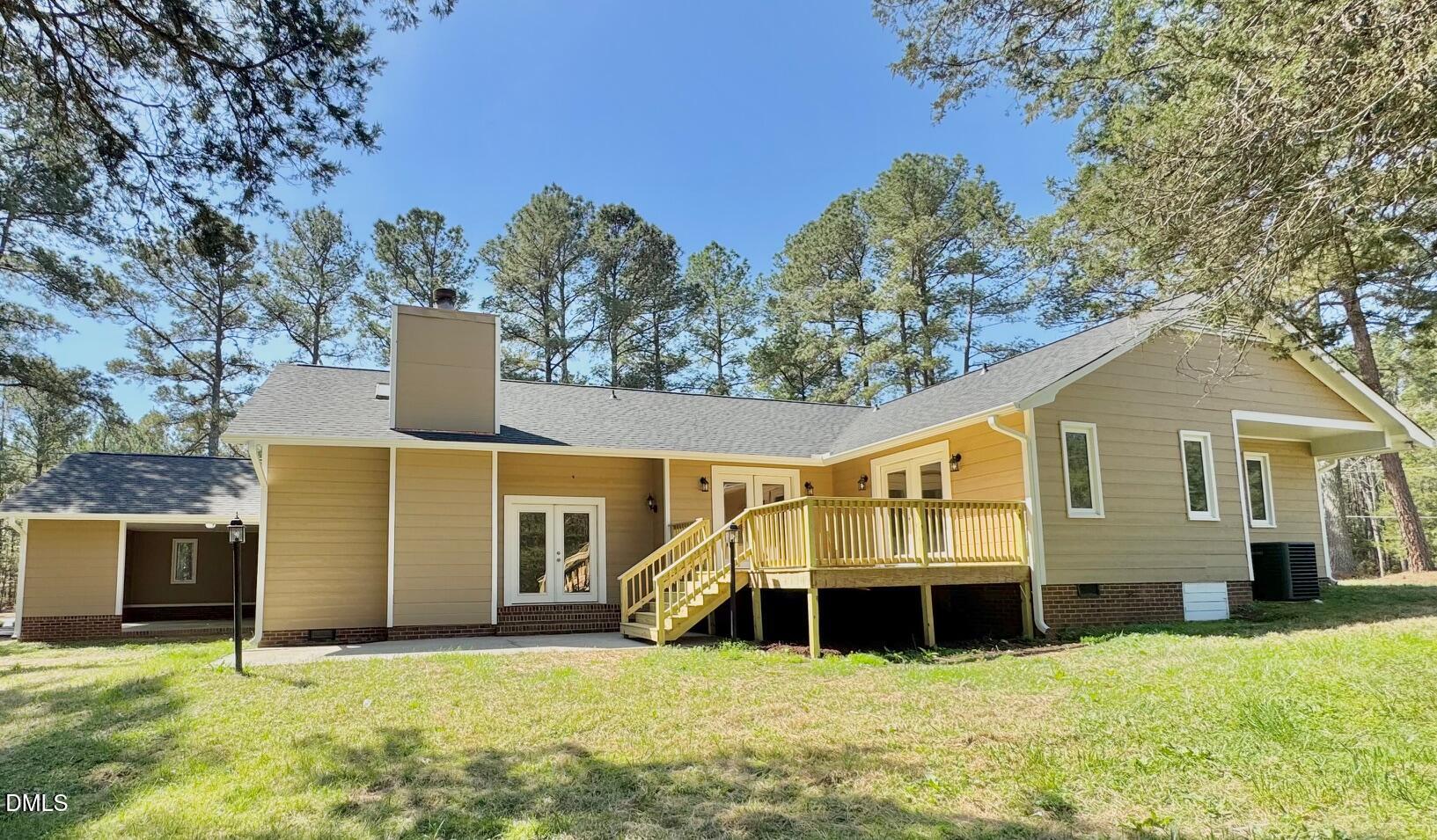 1720 Ross Mill Road Henderson, NC 27537 - Photo 2 of 42 a front view of a house with yard and garage
