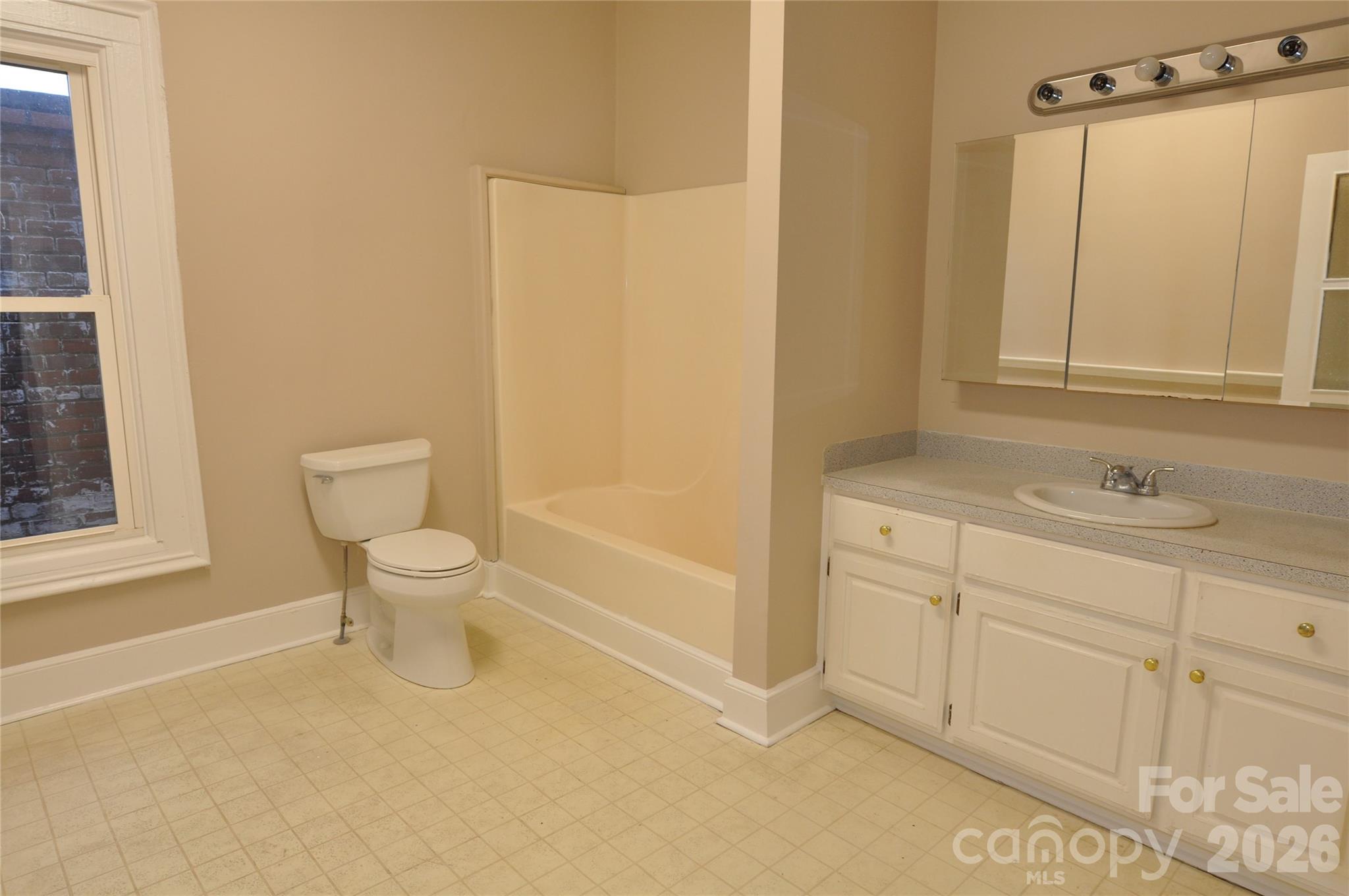 107 Gadsden Street, Unit A&B Chester, SC 29706 - Photo 13 of 20 a bathroom with a sink a toilet and shower