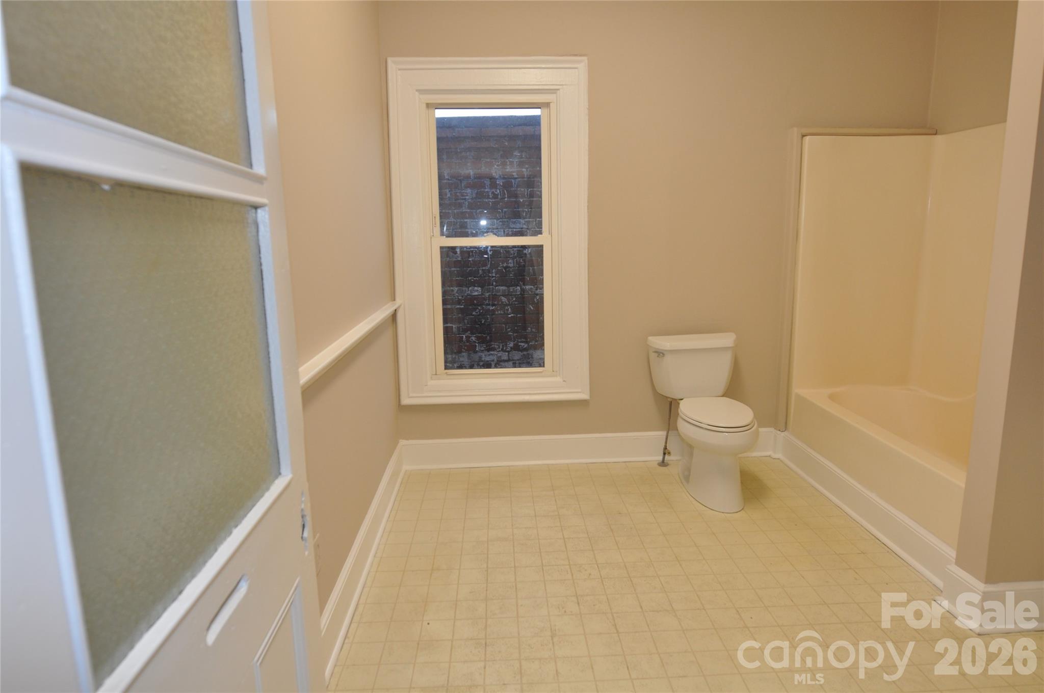 107 Gadsden Street, Unit A&B Chester, SC 29706 - Photo 14 of 20 a bathroom with a toilet and a shower