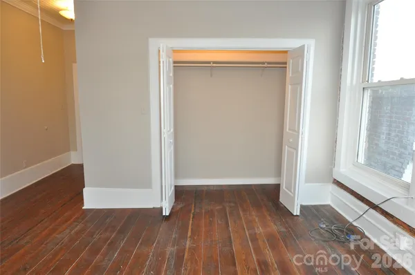 a view of a room with wooden floor