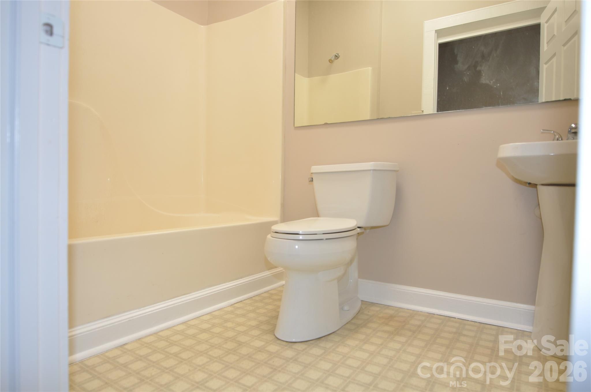 107 Gadsden Street, Unit A&B Chester, SC 29706 - Photo 18 of 20 a bathroom with a toilet and a mirror