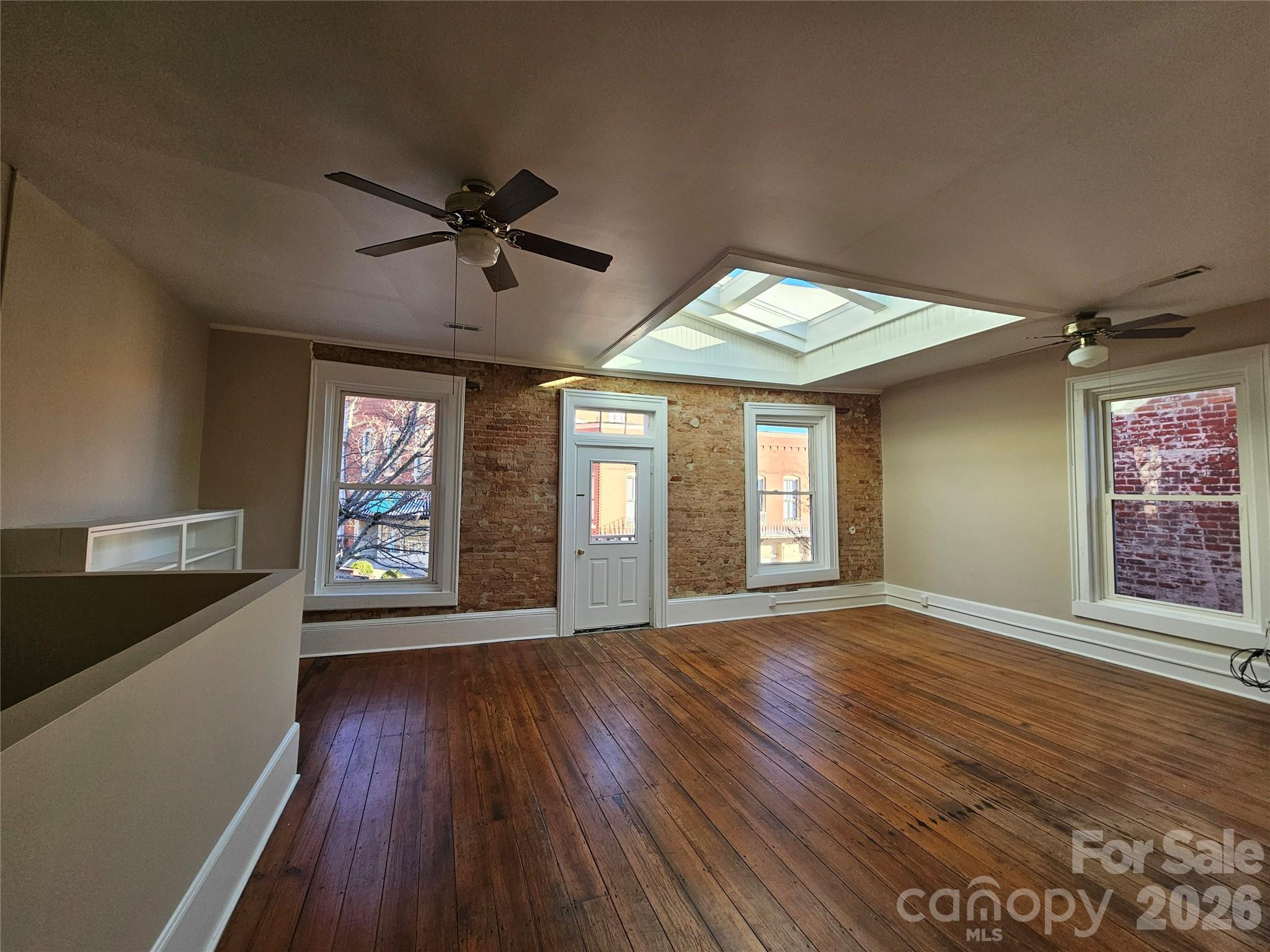 107 Gadsden Street, Unit A&B Chester, SC 29706 - Photo 19 of 20 a view of an empty room with a window and wooden floor