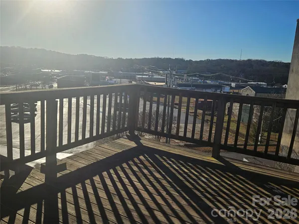 a view of a balcony with wooden floor