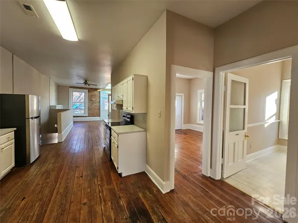 a view of a hallway view with wooden floor and living room