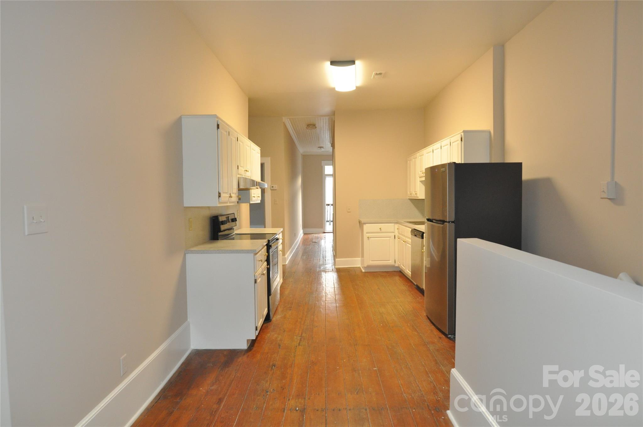 107 Gadsden Street, Unit A&B Chester, SC 29706 - Photo 3 of 20 a view of a kitchen with a sink and dishwasher a refrigerator with wooden floor