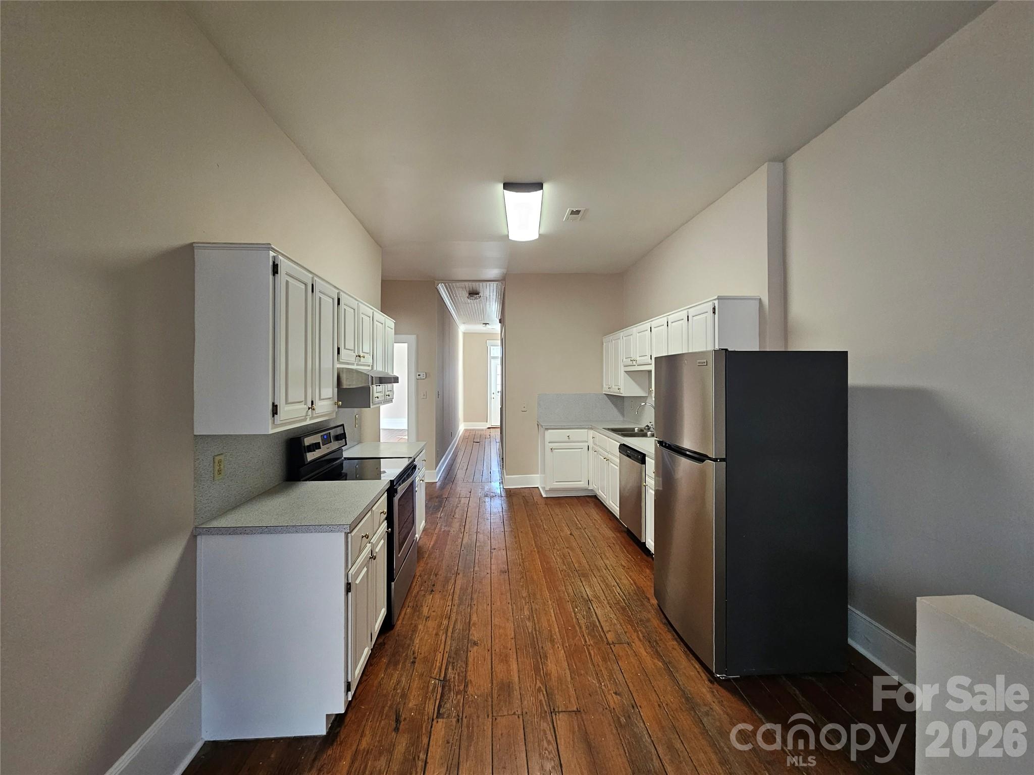 107 Gadsden Street, Unit A&B Chester, SC 29706 - Photo 6 of 20 a kitchen with a refrigerator a sink and wooden floor