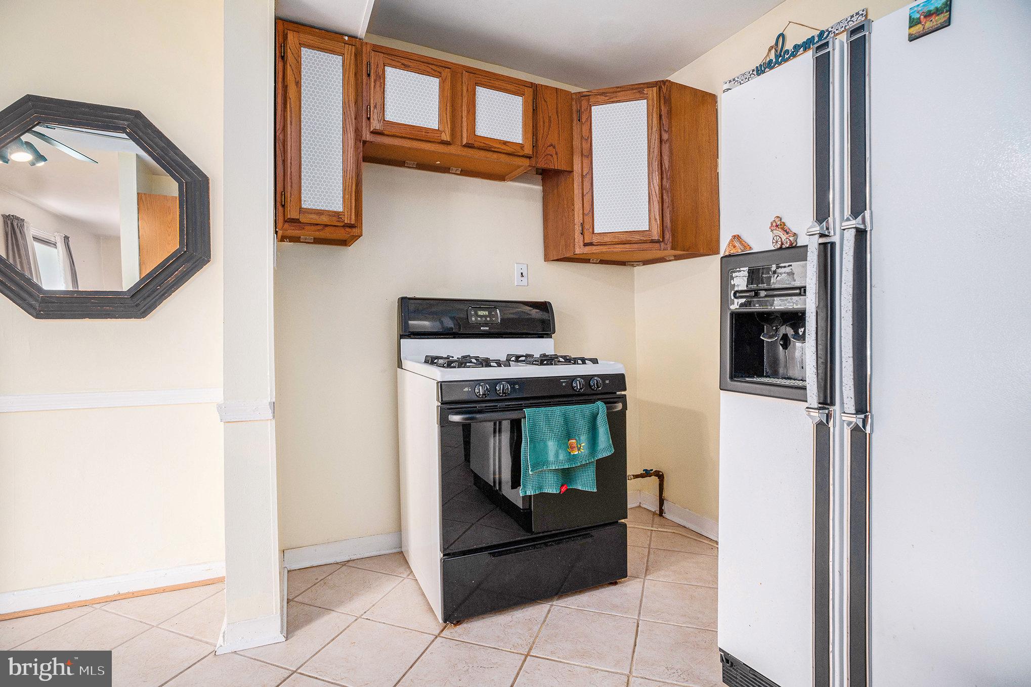326 East Rambo Street Bridgeport, PA 19405 - Photo 11 of 26 a kitchen with stainless steel appliances granite countertop a stove and a microwave
