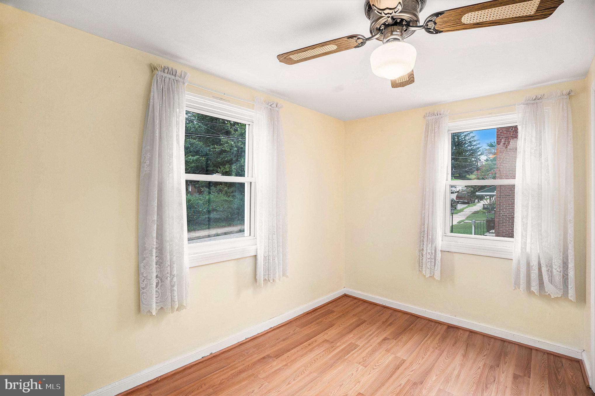 326 East Rambo Street Bridgeport, PA 19405 - Photo 17 of 26 an empty room with wooden floor fan and windows