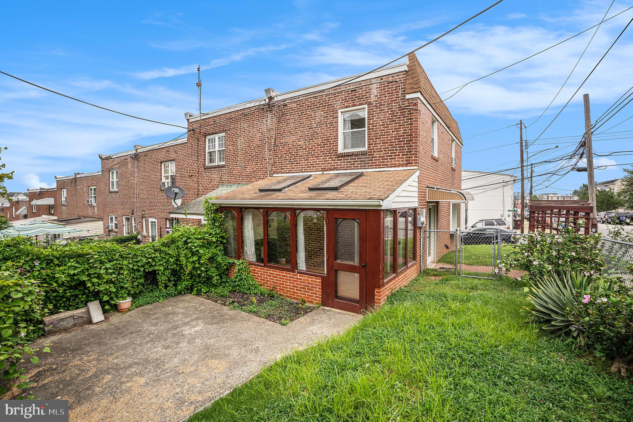326 East Rambo Street Bridgeport, PA 19405 - Photo 4 of 26 a view of a house with brick walls and a yard with plants