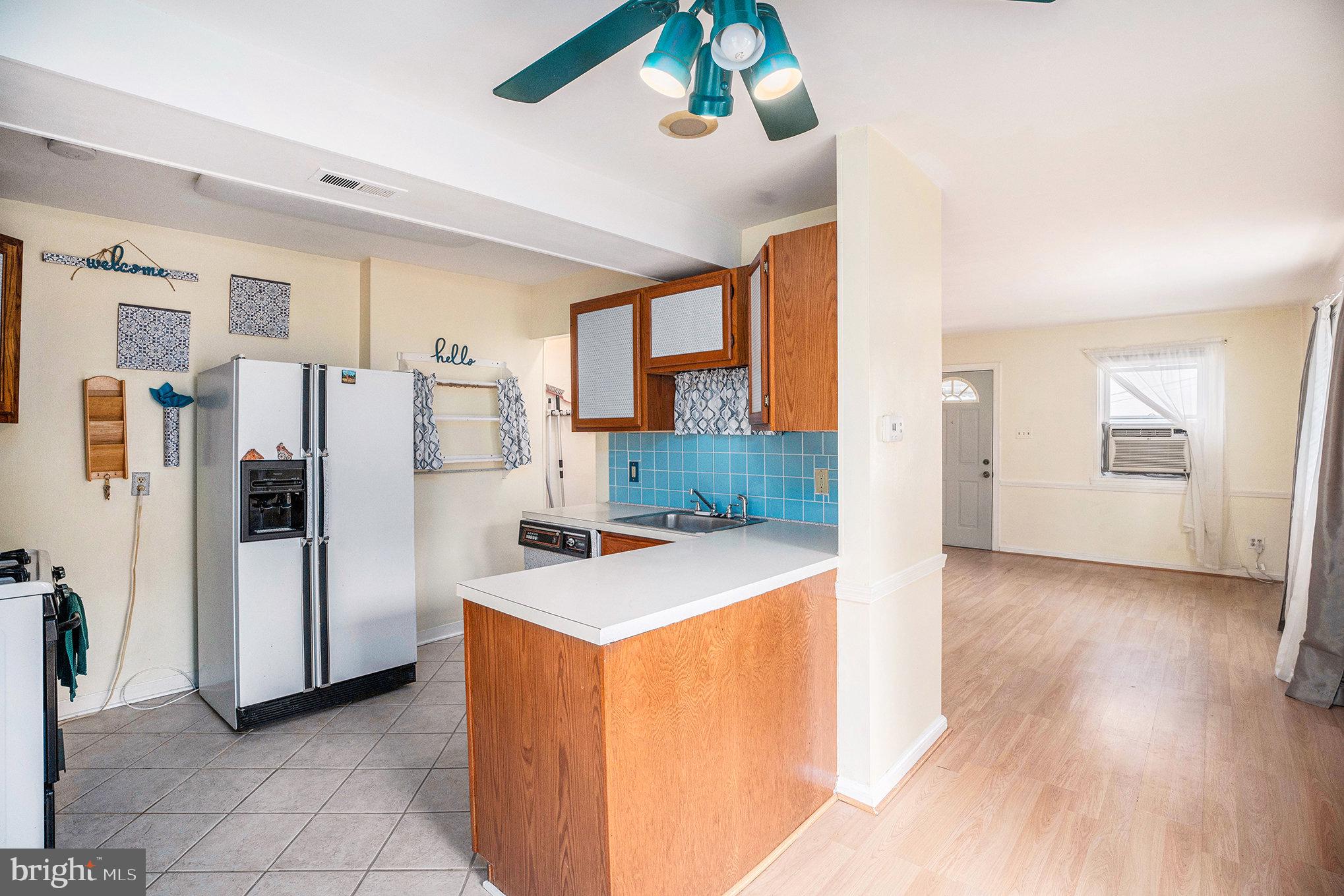 326 East Rambo Street Bridgeport, PA 19405 - Photo 10 of 26 a view of a kitchen with refrigerator and wooden floor