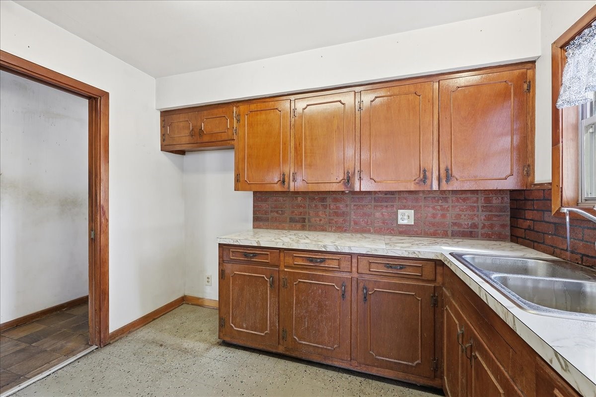 1709 West Robin Avenue Orange, TX 77632 - Photo 11 of 24 a kitchen with a sink and cabinets