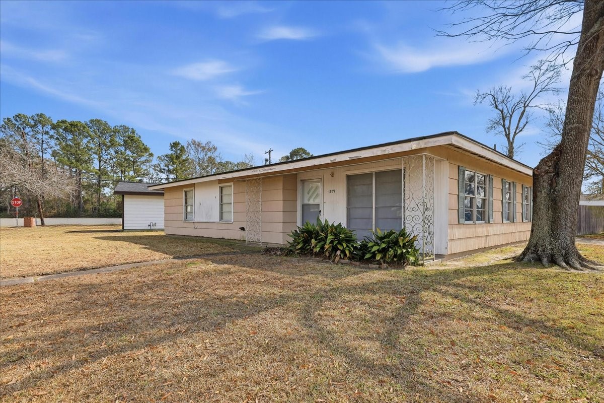1709 West Robin Avenue Orange, TX 77632 - Photo 2 of 24 a view of a house with a yard