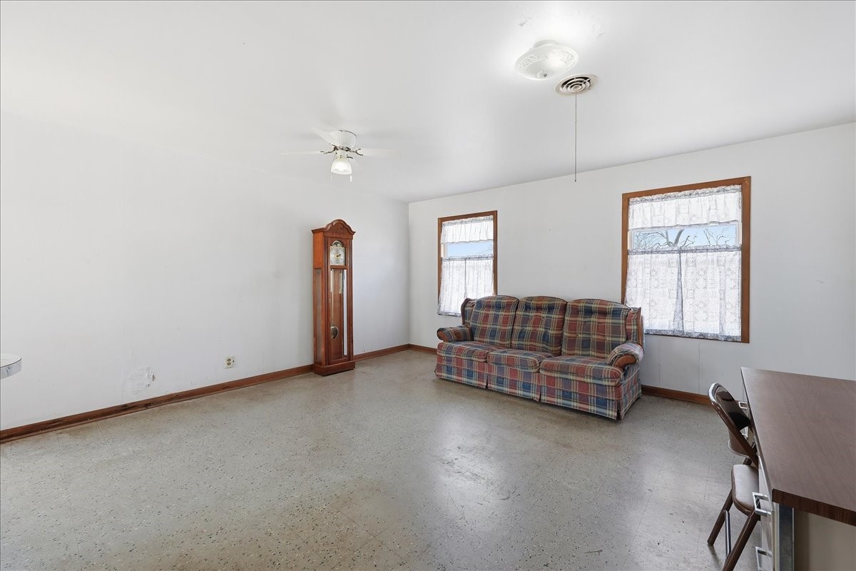 1709 West Robin Avenue Orange, TX 77632 - Photo 7 of 24 an empty room with windows and cabinet