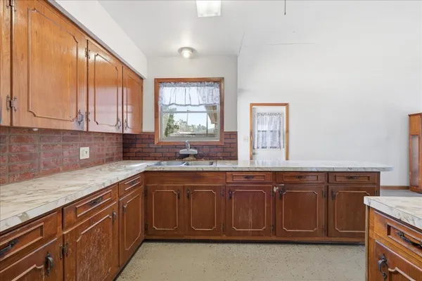 a kitchen with a sink and cabinets