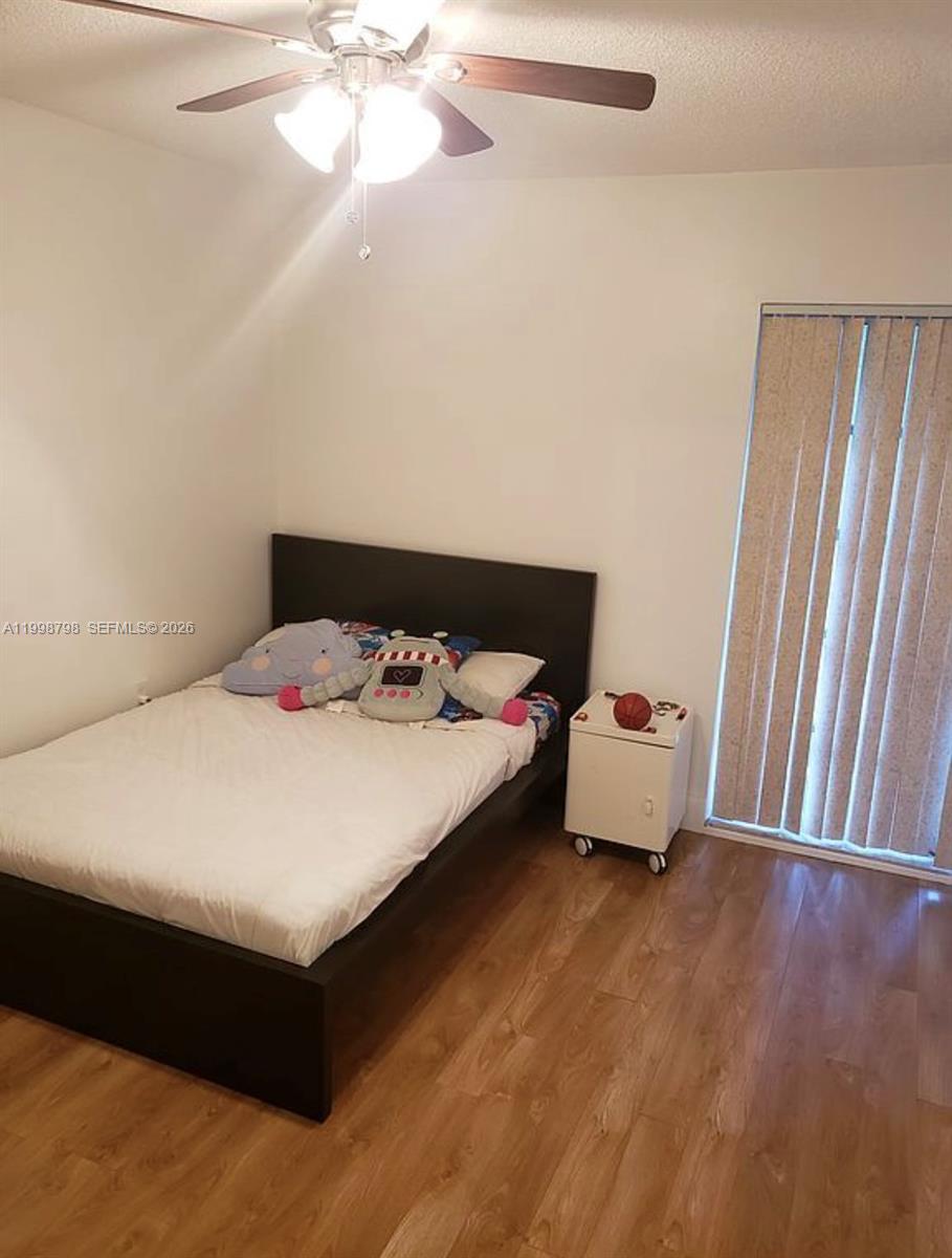 3301 Raleigh Street, Unit 4A Hollywood, FL 33021 - Photo 10 of 11 a bedroom with a bed and window