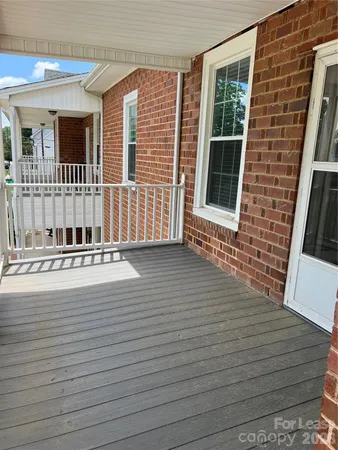 a view of a house with wooden deck