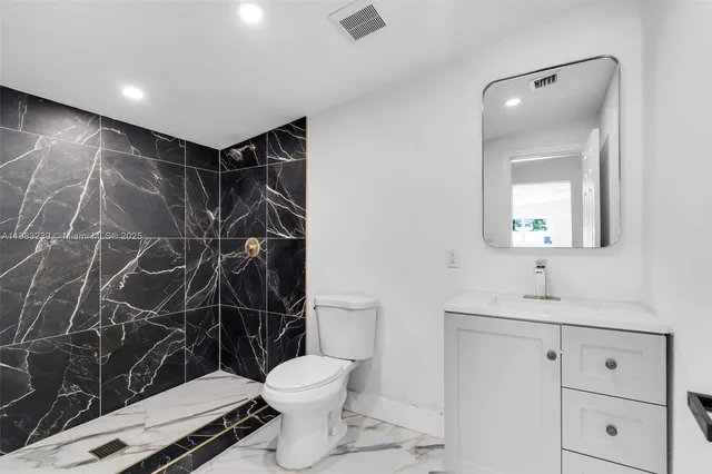 a bathroom with a toilet sink and shower