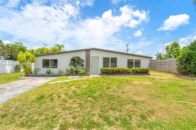 a view of a house with a swimming pool and a yard