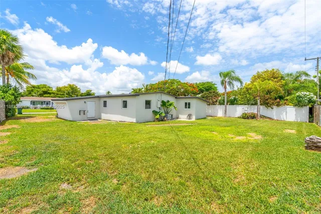 a view of a big yard with table and chairs and plants