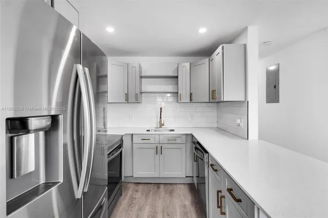 a kitchen with stainless steel appliances a sink stove and refrigerator