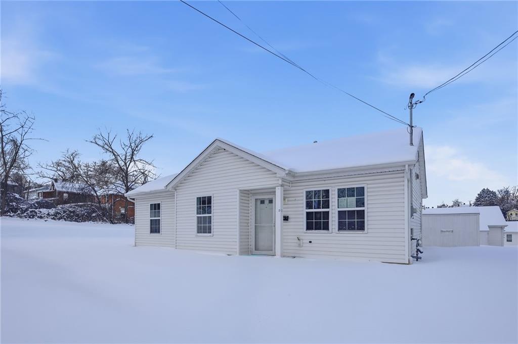 a view of a house with a snow in the yard