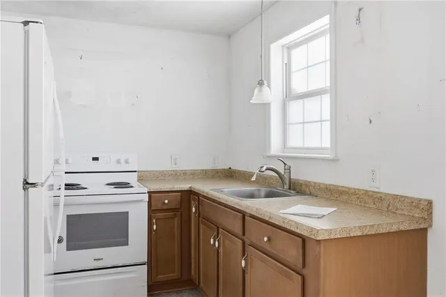 a kitchen with a sink stove and cabinets